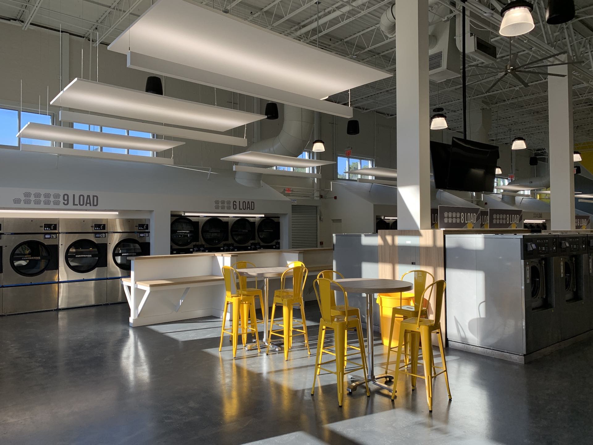 Six-load washers, seating and TVs at Oz Laundry in Decatur