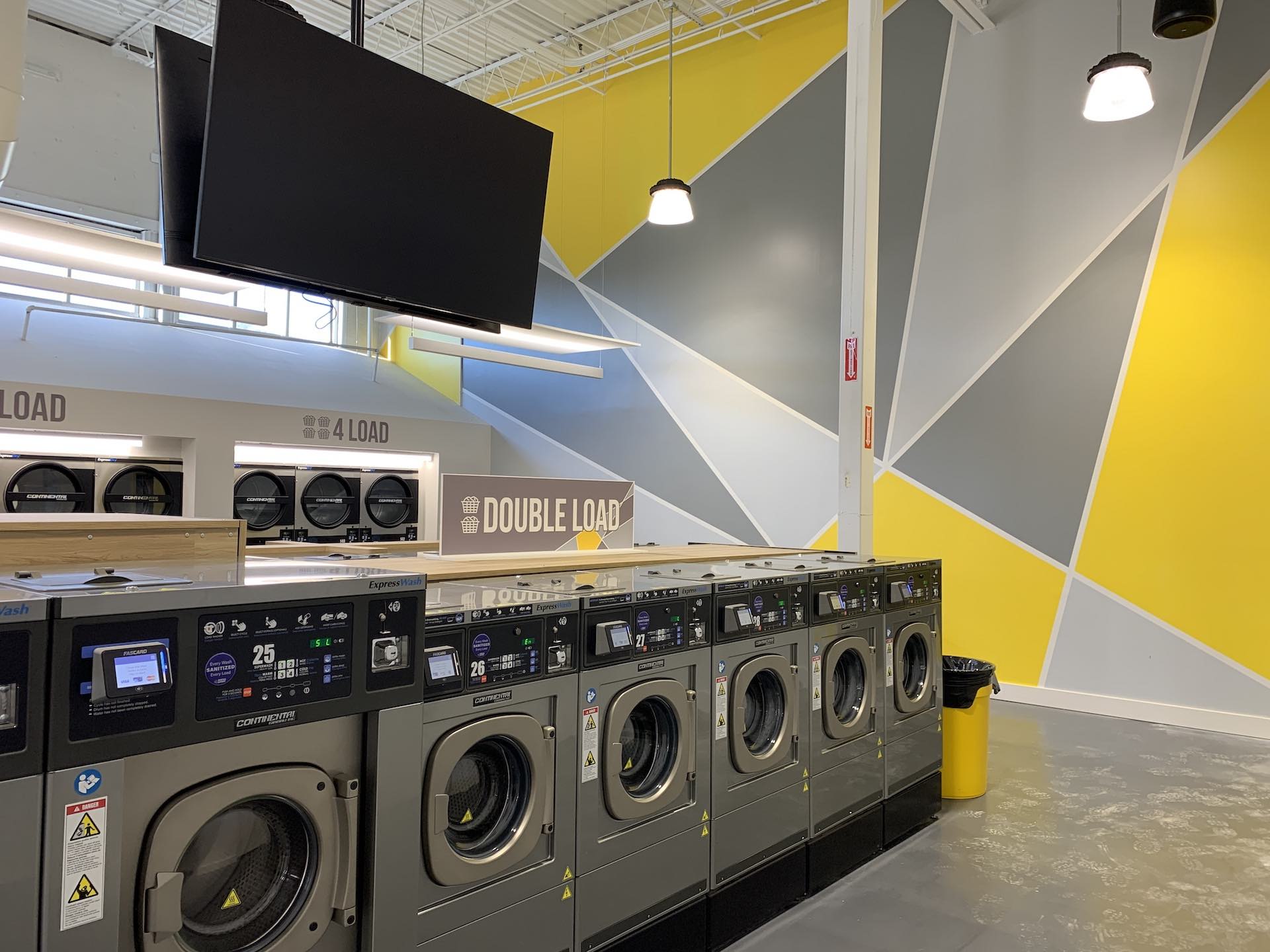 Oz Laundry brand mural above the double-load washers
